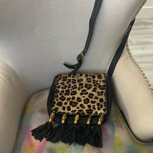 Black crossbody bag with adjustable strap animal print fur on front of bag